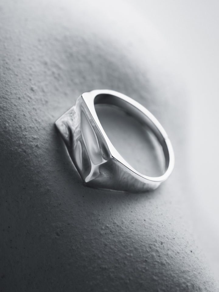 Silver ring on a textured gray surface
