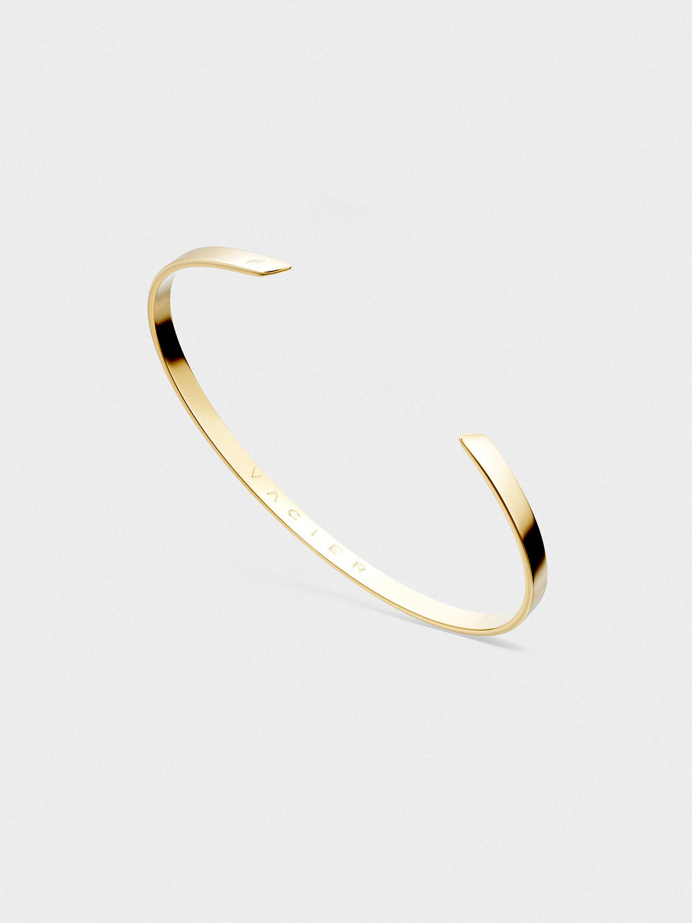 Gold cuff on a light gray background