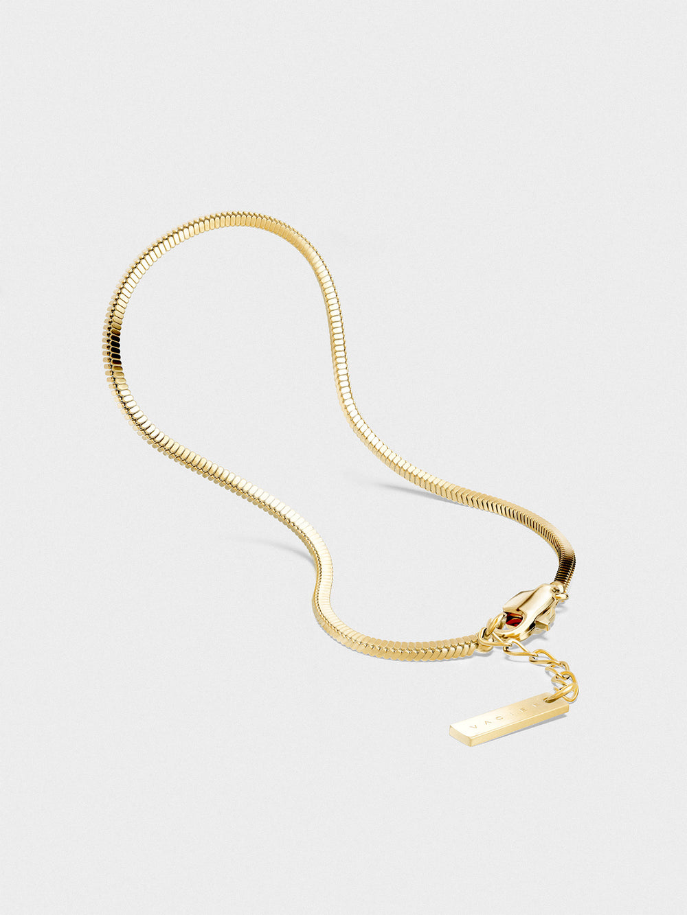 Gold bracelet on a light gray background.