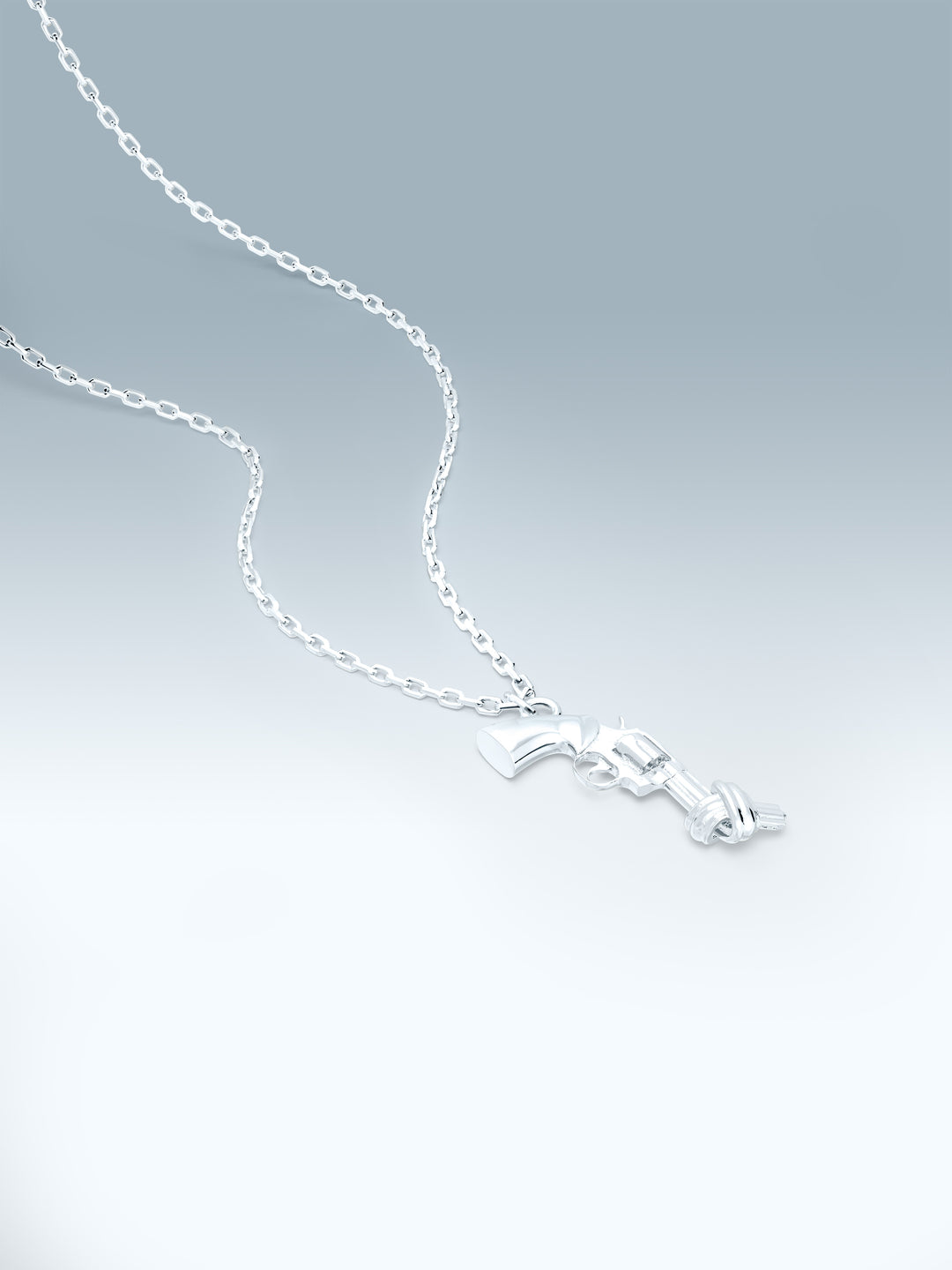 Silver necklace with a unique pendant on a light gray background