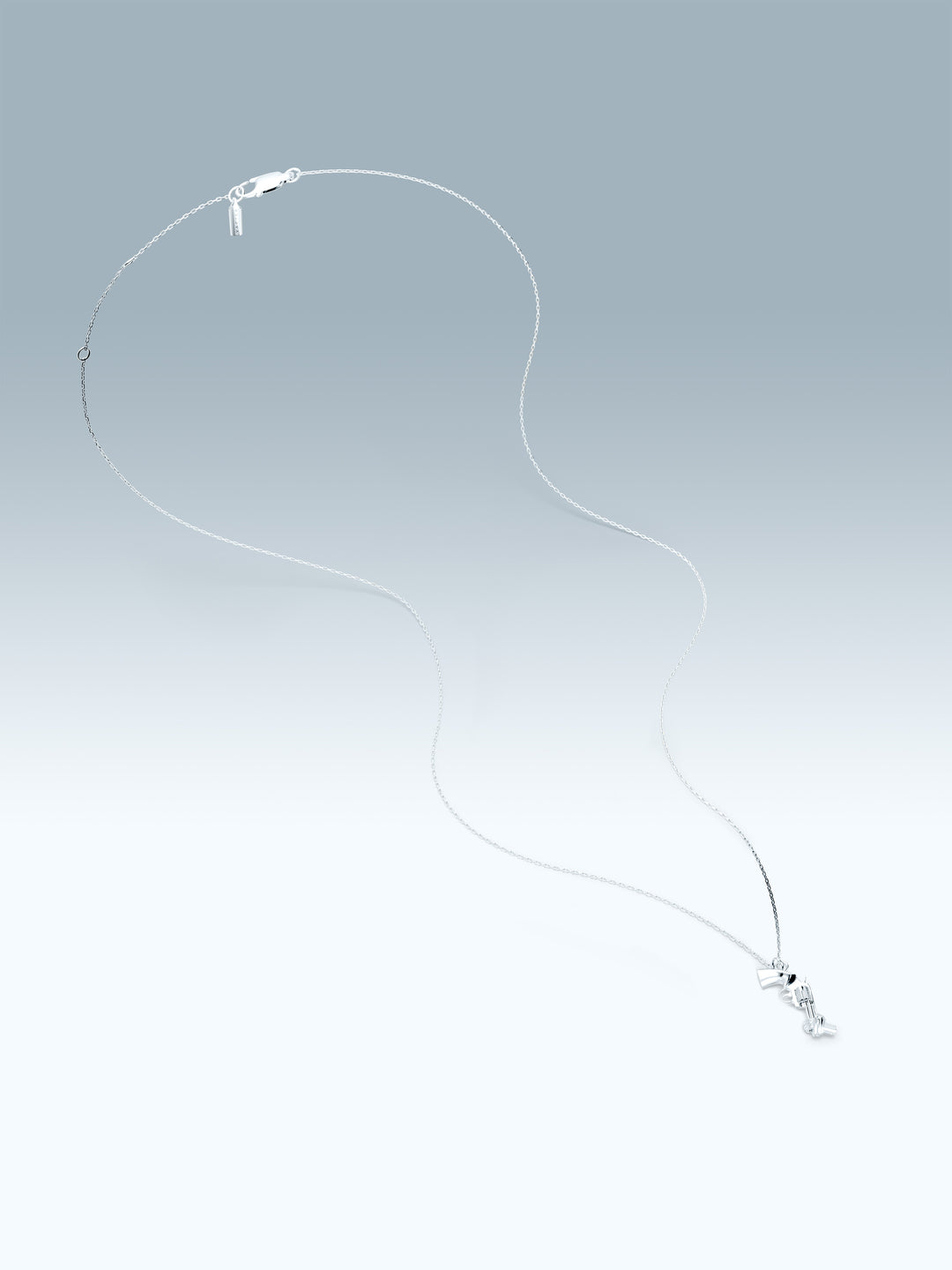 Silver necklace with a non-violence pendant on a gradient gray background