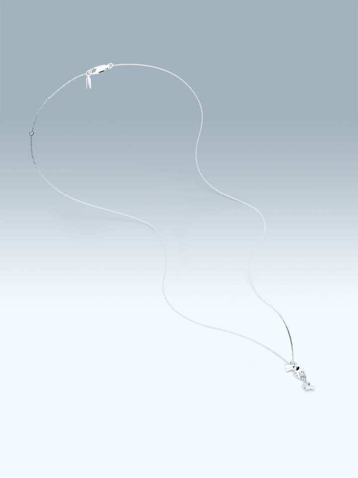 Silver necklace with a non-violence pendant on a gradient gray background