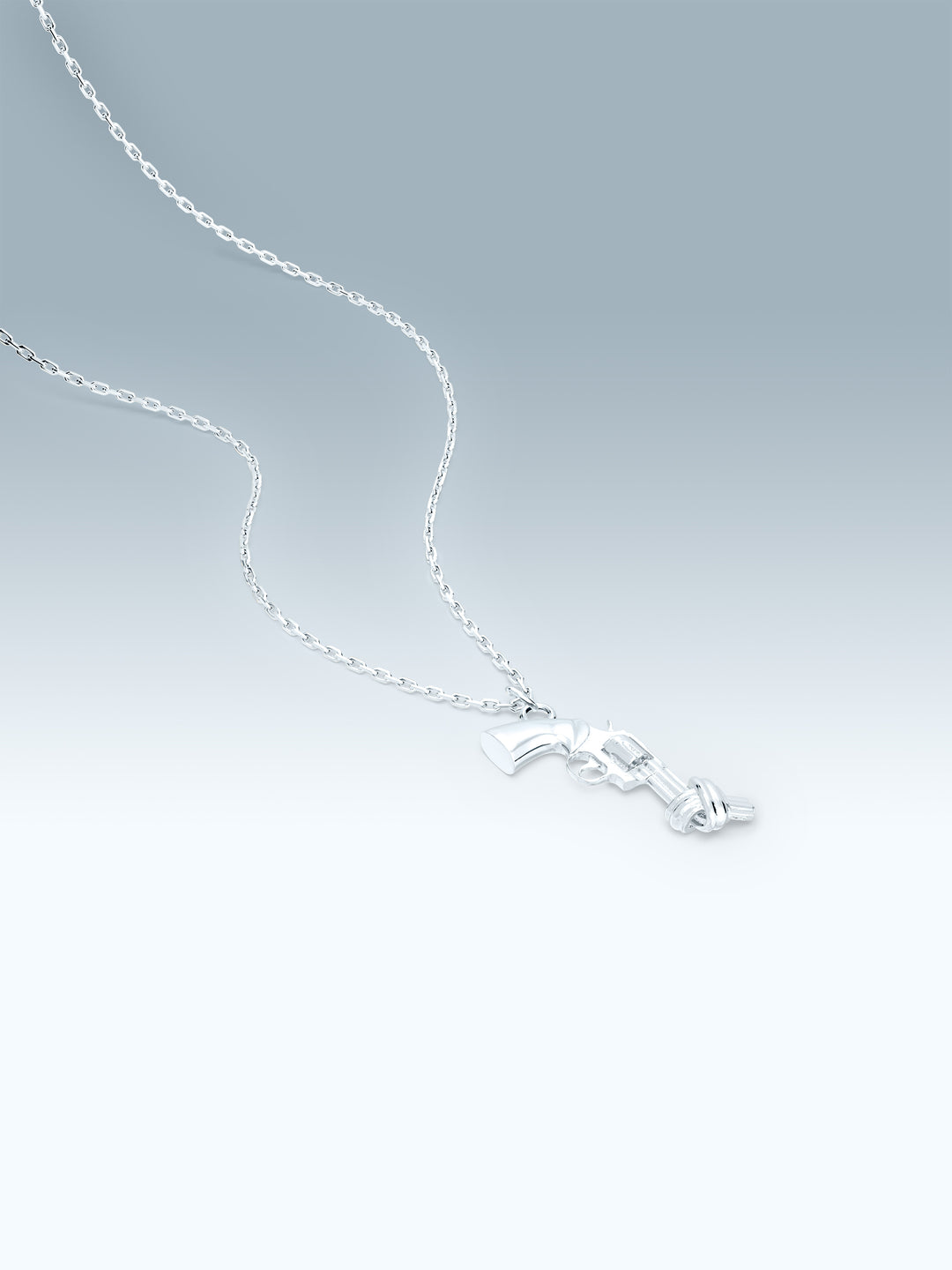 Silver necklace with a non-violence pendant on a gradient gray background