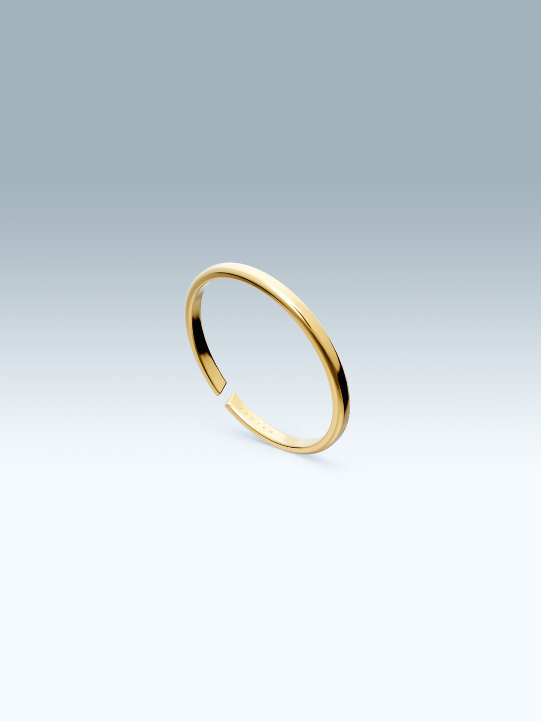 Gold vacier linear ring on a light gray background