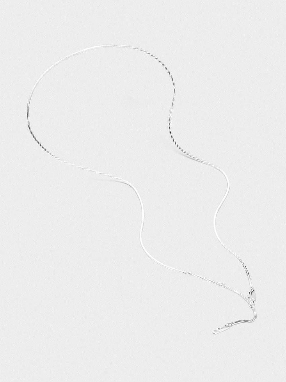 Silver necklace on a white background.